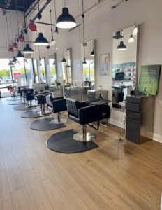 Interior of Fusion Salon in Jacksonville featuring modern hair styling stations and expert Aveda color and extension services.